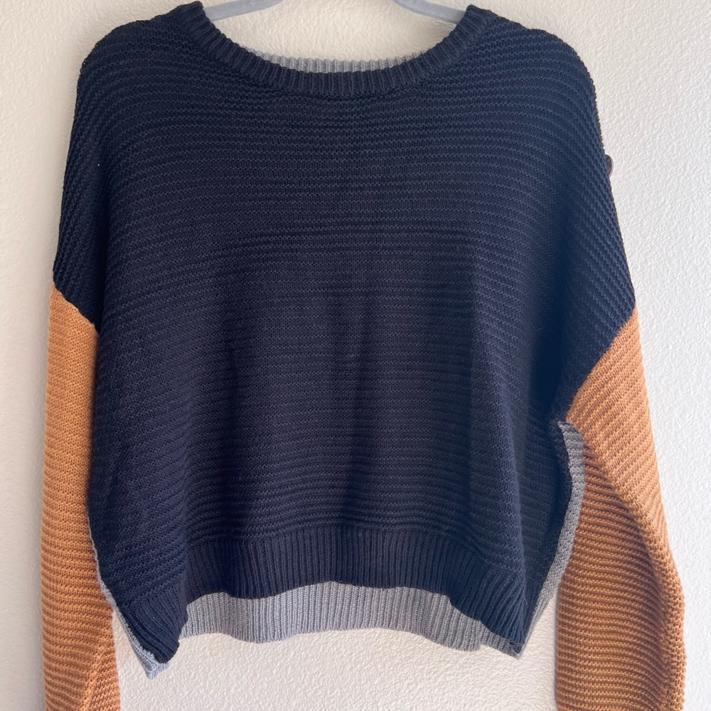 Woman’s adorable sweater with buttons on one of the sleeves from Rue21.